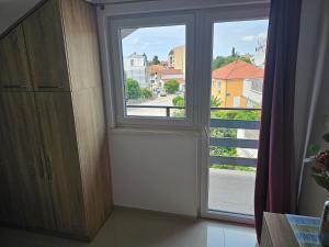 a room with a window with a view of a street at Elizabeta Deluxe Rooms in Biograd na Moru