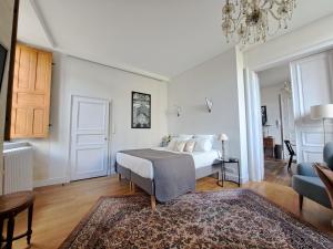 a bedroom with a bed and a living room at LA MAISON CANONIALE luxe et charme au coeur de Tours in Tours