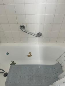 a bath tub with a metal rack in a bathroom at maison de 100 m2 comprenant 3 chambres avec jardin in Dun-sur-Grandry +29 photos