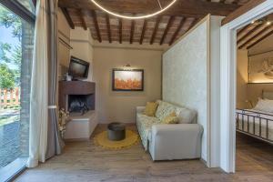 a living room with a couch and a fireplace at Casa Ciculino 8, Emma Villas in Monteleone dʼOrvieto