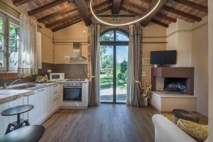 a kitchen with a large window and a living room at Casa Ciculino 8, Emma Villas in Monteleone dʼOrvieto