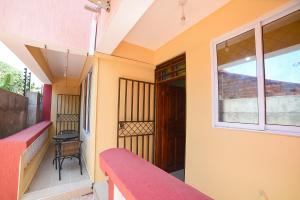 a balcony with a red bench and a window at MAXIMILIAN HOMES in Kilifi