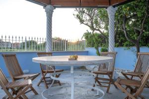 a white table and chairs on a patio with a table and chairs at DIMORA BORDIN Luxury Aparthotel Animali ammessi in Nettuno