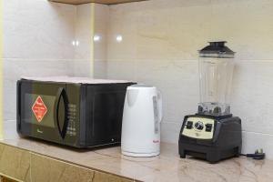 a kitchen counter with a toaster and a blender at MAXIMILIAN HOMES in Kilifi