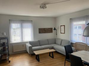 a living room with a couch and a table at Hvide Sande Hotel in Hvide Sande