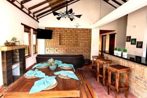 a dining room with a table with blue napkins on it at Casa de las Flores- Chalet Privado in Villa de Leyva