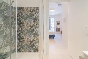 a hallway with a wall mural of palm trees at Dimore delle Zagare Molo in Syracuse