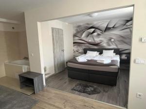 A bed or beds in a room at Brill Hotel Békéscsaba