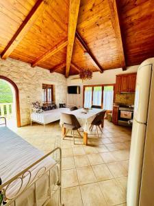 a kitchen and living room with a table and chairs at Deep Blue Villas in Vasilikos
