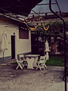 a patio with a table and chairs and an umbrella at Casa Vacanze Terra di Mezzo in Invorio Inferiore
