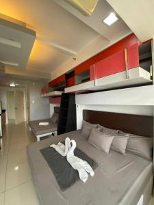 a bedroom with a bed with towels on it at D Luckycharm staycation in Tagaytay +32 photos