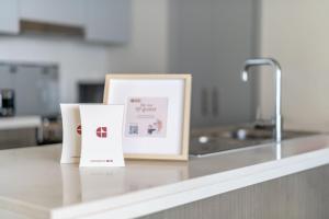 a kitchen counter with two cards and a sink at GuestReady - Glamourous home in Downtown Dubai in Dubai