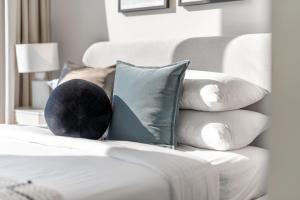 a pile of pillows sitting on a white couch at GuestReady - Glamourous home in Downtown Dubai in Dubai