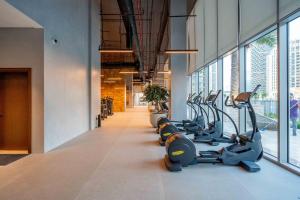a row of exercise bikes in a gym at GuestReady - Glamourous home in Downtown Dubai in Dubai