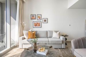 a living room with a couch and a table at GuestReady - Glamourous home in Downtown Dubai in Dubai