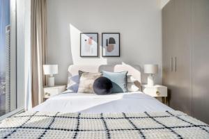 a man laying on a bed in a bedroom at GuestReady - Glamourous home in Downtown Dubai in Dubai