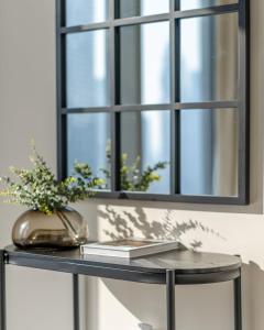 a table with a mirror and a book on it at GuestReady - Glamourous home in Downtown Dubai in Dubai
