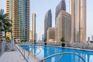 a swimming pool in a city with tall buildings at GuestReady - Glamourous home in Downtown Dubai in Dubai