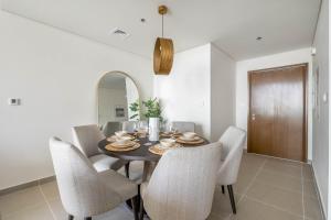 a dining room with a table with chairs and a mirror at GuestReady - Glamourous home in Downtown Dubai in Dubai