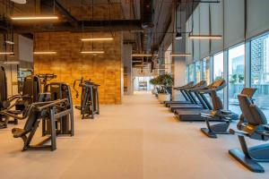 a gym with treadmills and elliptical machines at GuestReady - Glamourous home in Downtown Dubai in Dubai