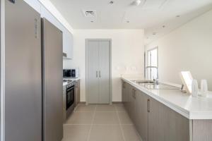 a kitchen with white walls and a white counter top at GuestReady - Glamourous home in Downtown Dubai in Dubai