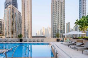a swimming pool on the roof of a building with tall buildings at GuestReady - Glamourous home in Downtown Dubai in Dubai