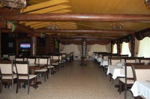 a row of tables and chairs in a room at Zatyshok in Svalyava