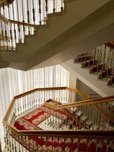 a room with stairs and a red rug on the floor at Natsionalny Hotel in Kyiv