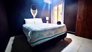 a bedroom with a bed with a mirror on the wall at Playa Del Carmen Apartment in Playa del Carmen