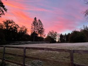 Una puesta de sol sobre un campo con una valla en Etzauer Mühle im Taunus, en Weilrod