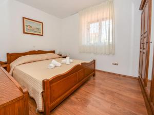 a bedroom with a bed with two towels on it at Holiday Home Marko by Interhome in Sukošan