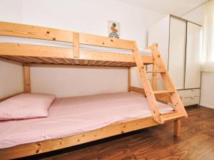 a bunk bed with a ladder in a room at Holiday Home Marko by Interhome in Sukošan