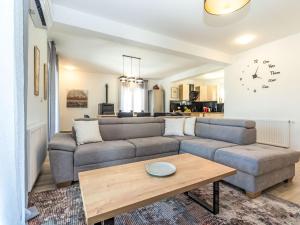 a living room with a couch and a table at Holiday Home Villa Šime by Interhome in Vlašnović