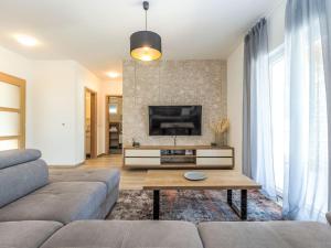 a living room with a couch and a tv at Holiday Home Villa Šime by Interhome in Vlašnović