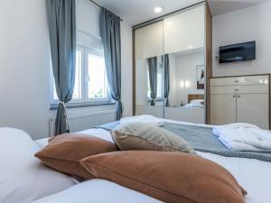a bedroom with two beds and a mirror at Holiday Home Villa Šime by Interhome in Vlašnović +19 photos