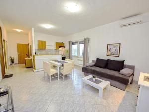 a living room with a couch and a table at Holiday Home Vesna by Interhome in Tučepi
