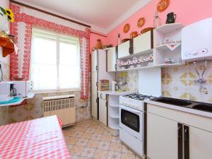 a kitchen with pink walls and a white stove top oven at Holiday Home Pomme by Interhome in Balatonkeresztúr