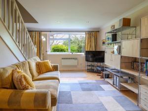 a living room with a couch and a television at 50 Fernhill Heights in Bridport