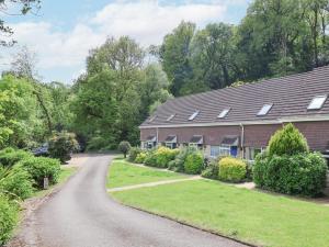 a road leading to a house with solar panels on the roof at 50 Fernhill Heights in Bridport