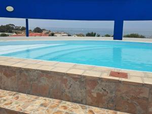a large swimming pool with blue water in a house at St Helena Bay Hotel in St. Helena Bay
