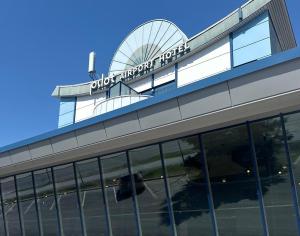 a building with a sign on the top of it at Pilot Airport Hotel in Vantaa