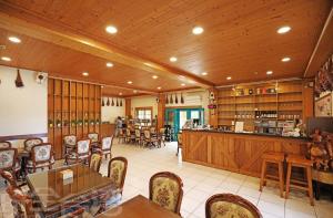 a restaurant with a bar and tables and chairs at 清境 百里莊園 Baili Manor Cing Jing in Ren'ai