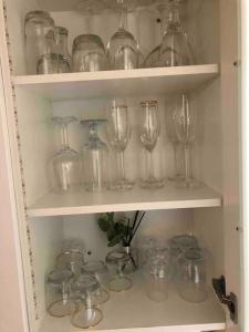 a cupboard filled with lots of glassases at Airbnb at Bailyes in Pretoria