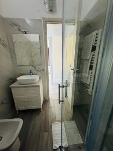a bathroom with a sink and a toilet and a shower at Casa L'Aquila in Como