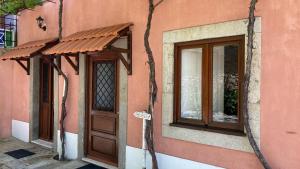 a building with a door and a window at Quintinha de Santiago in Oliveira de Azemeis