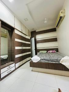 1 dormitorio con 1 cama grande y espejo en Temple View Home Stay en Tiruvannāmalai