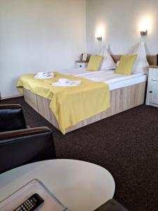 a hotel room with two beds and a table at Chalet Tinelu Brașov Săcele in Săcele +9 photos