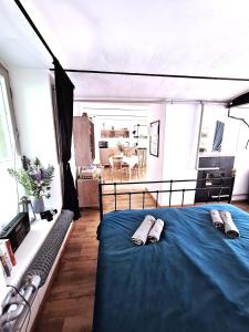 a bedroom with a blue bed with two pillows on it at Zielona Samotnia in Czaplinek