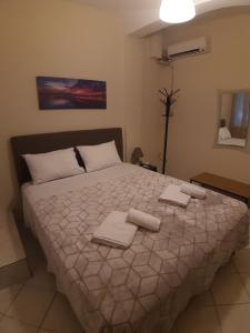 um quarto com uma cama grande e toalhas em Central AXD em Alexandroúpolis