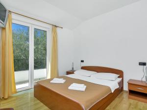 a bedroom with a large bed with two towels on it at Apartment Rubin-8 by Interhome in Zastražišće